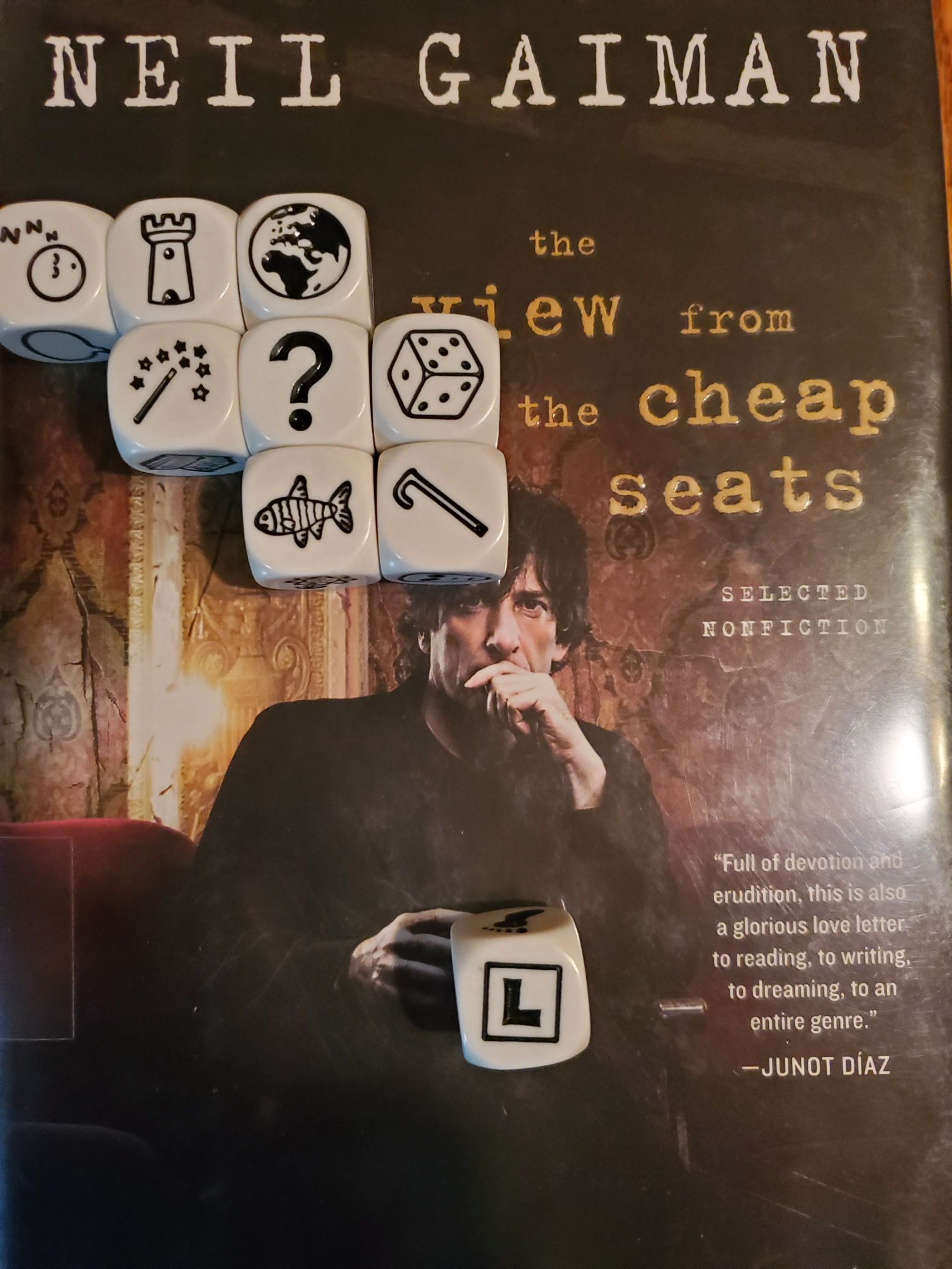 Sunday Story Cubes 4 on top of Neil Gaiman's "The View From the Cheap Seats"