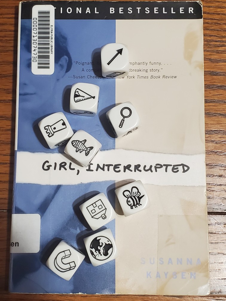 Story Cubes roll on top of Susanna Kaysen's "Girl, Interrupted"