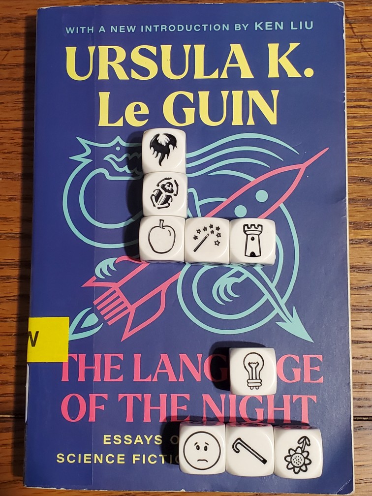 Story Cubes on top of Ursula K. Le Guin's "The Language of the Night"