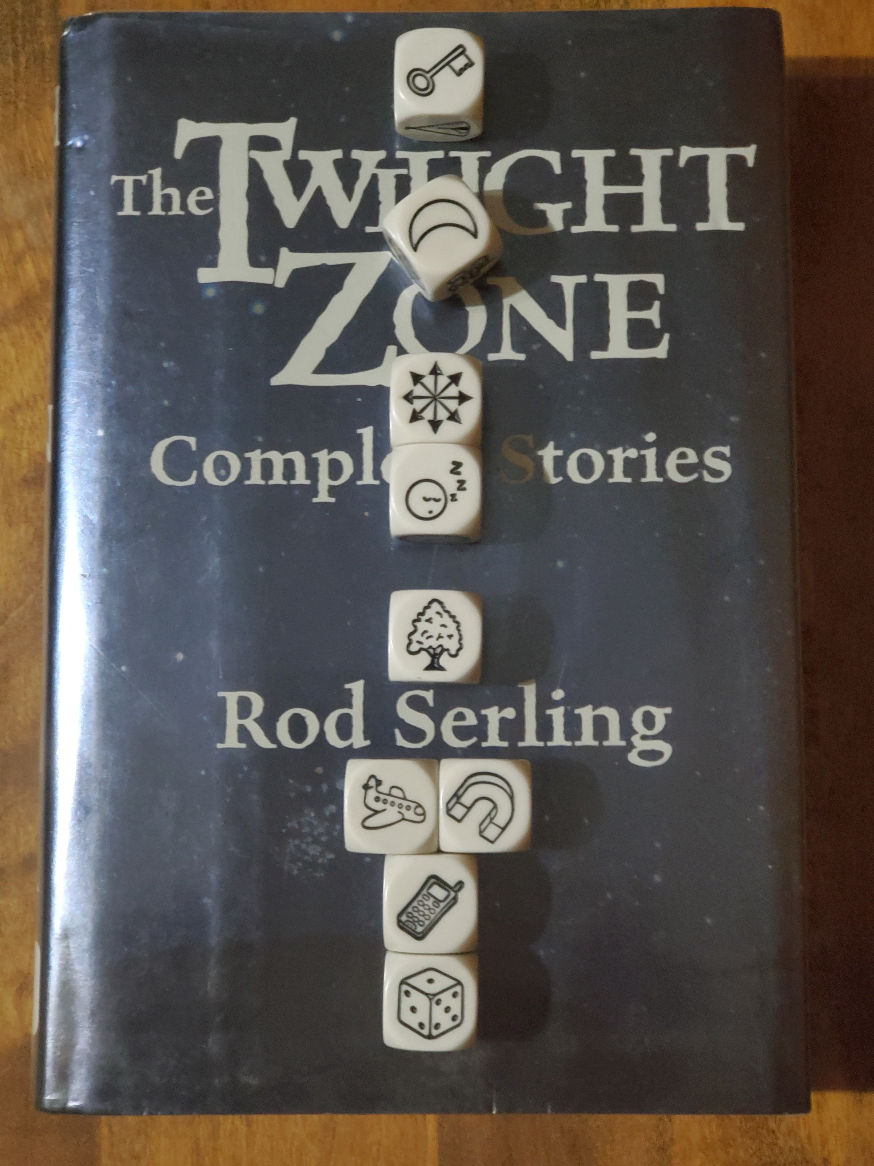 Story Cubes on top of "The Twilight Zone: Complete Stories" by Rod Serling