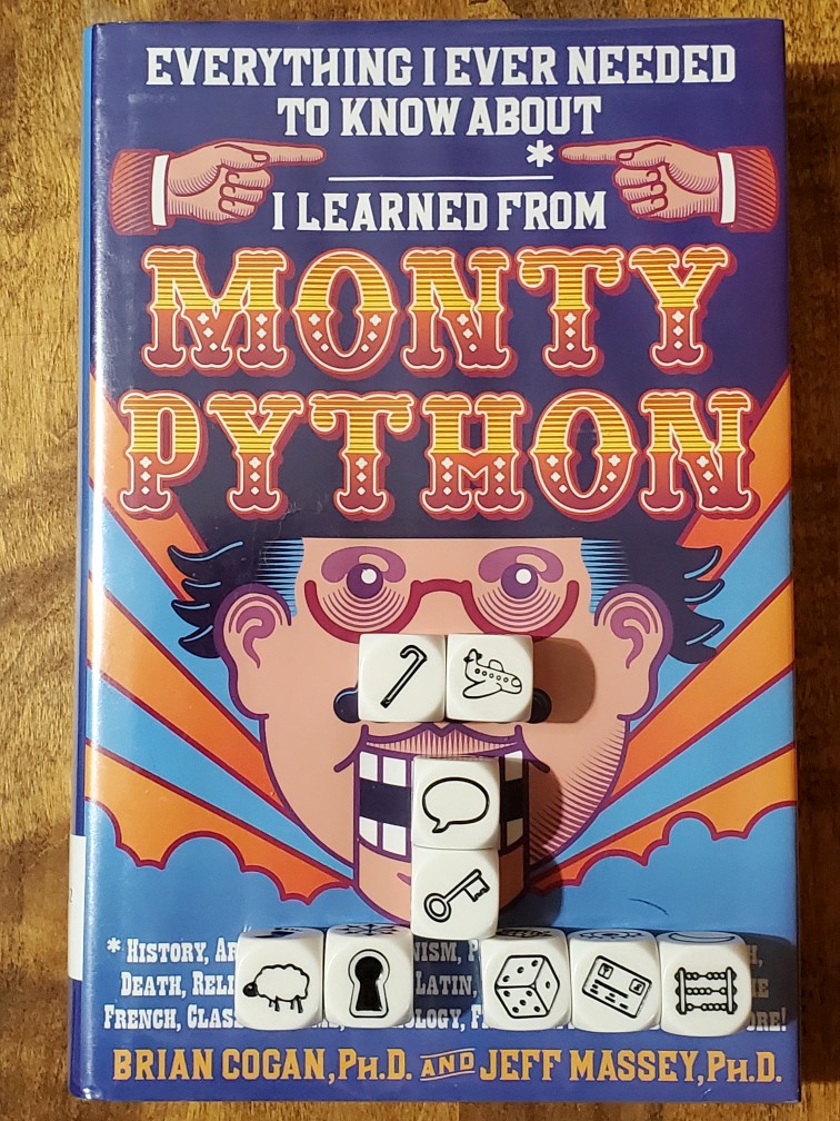 Story Cubes on top of "Everything I Ever Needed to Know I Learned from Monty Python" by Brian Cogan and Jeff Massey