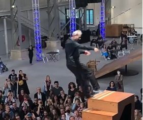 Yoann Bourgeois falling from a set of stairs onto a trampoline
