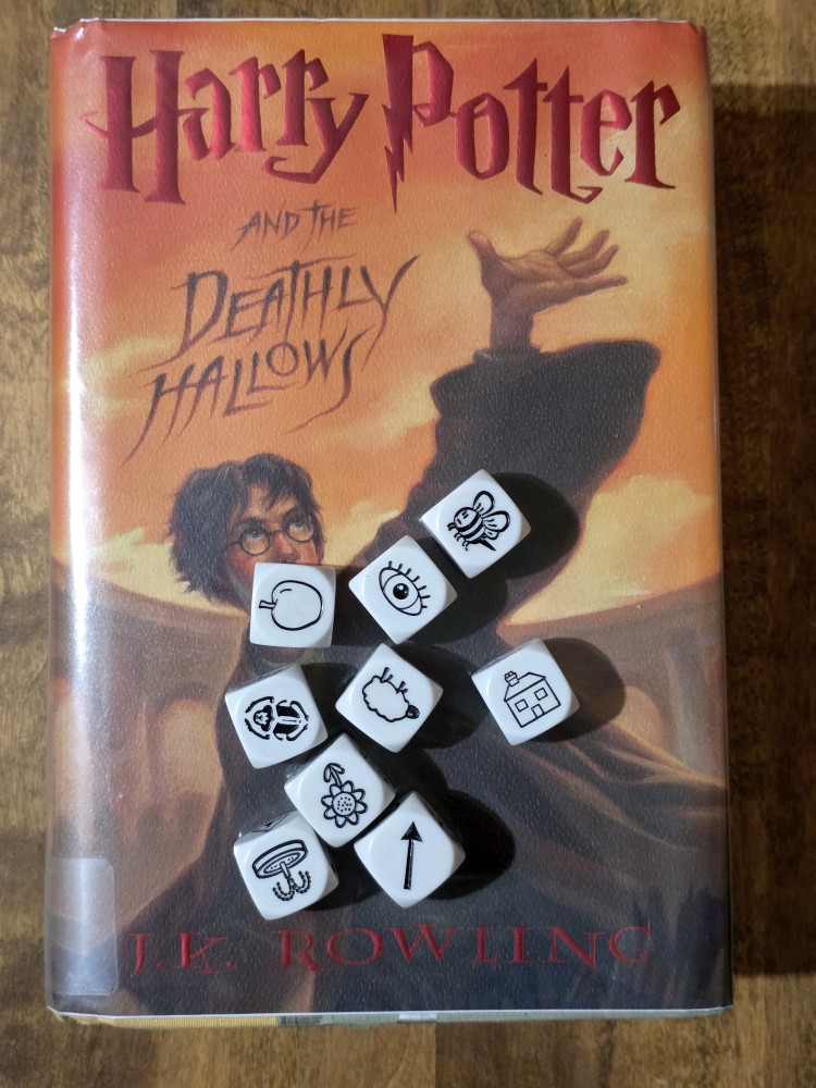 Story Cubes roll on top of Harry Potter and the Deathly Hallows by J. K. Rowling